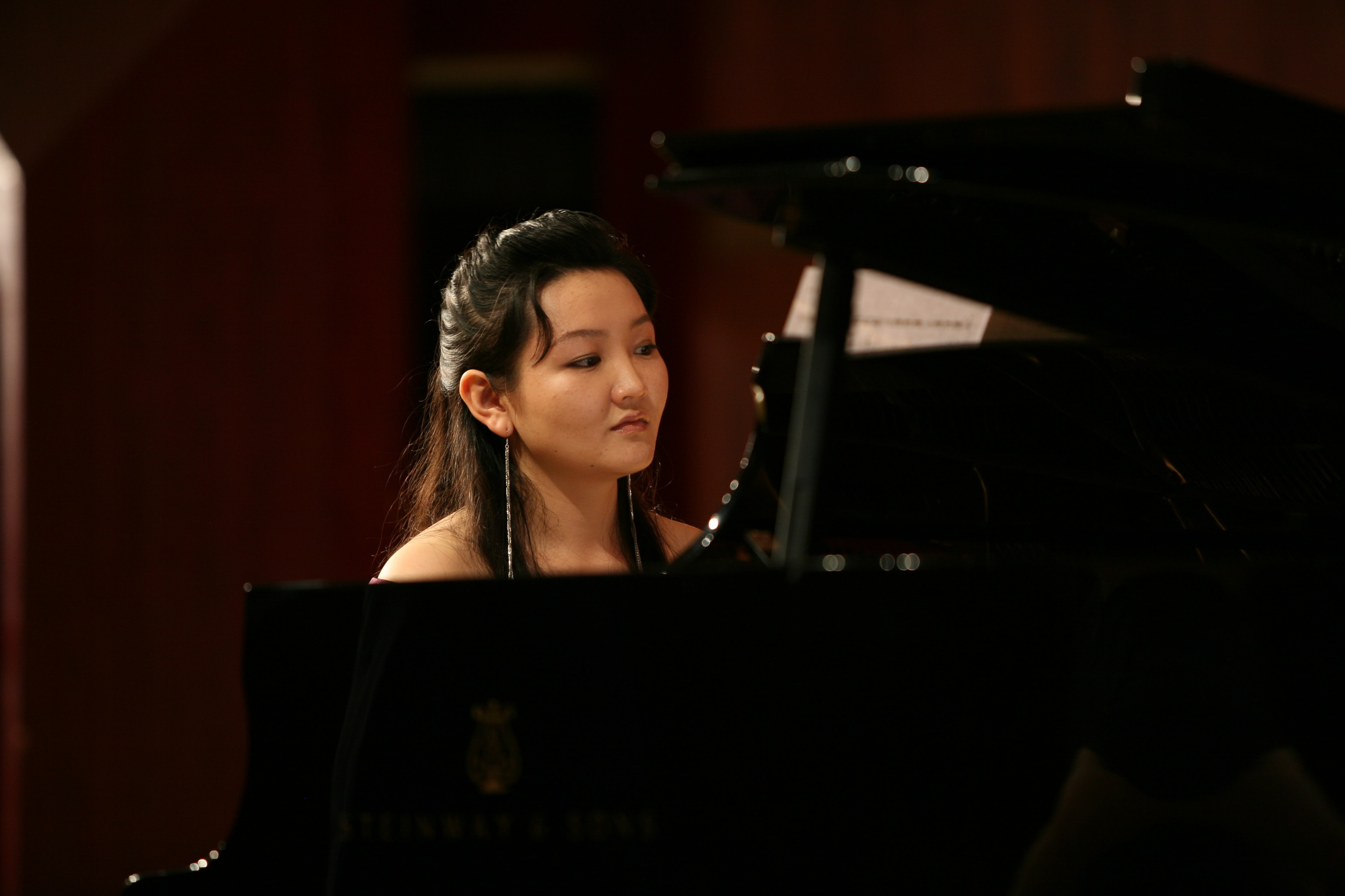 Pianist rehearsing at a grand piano