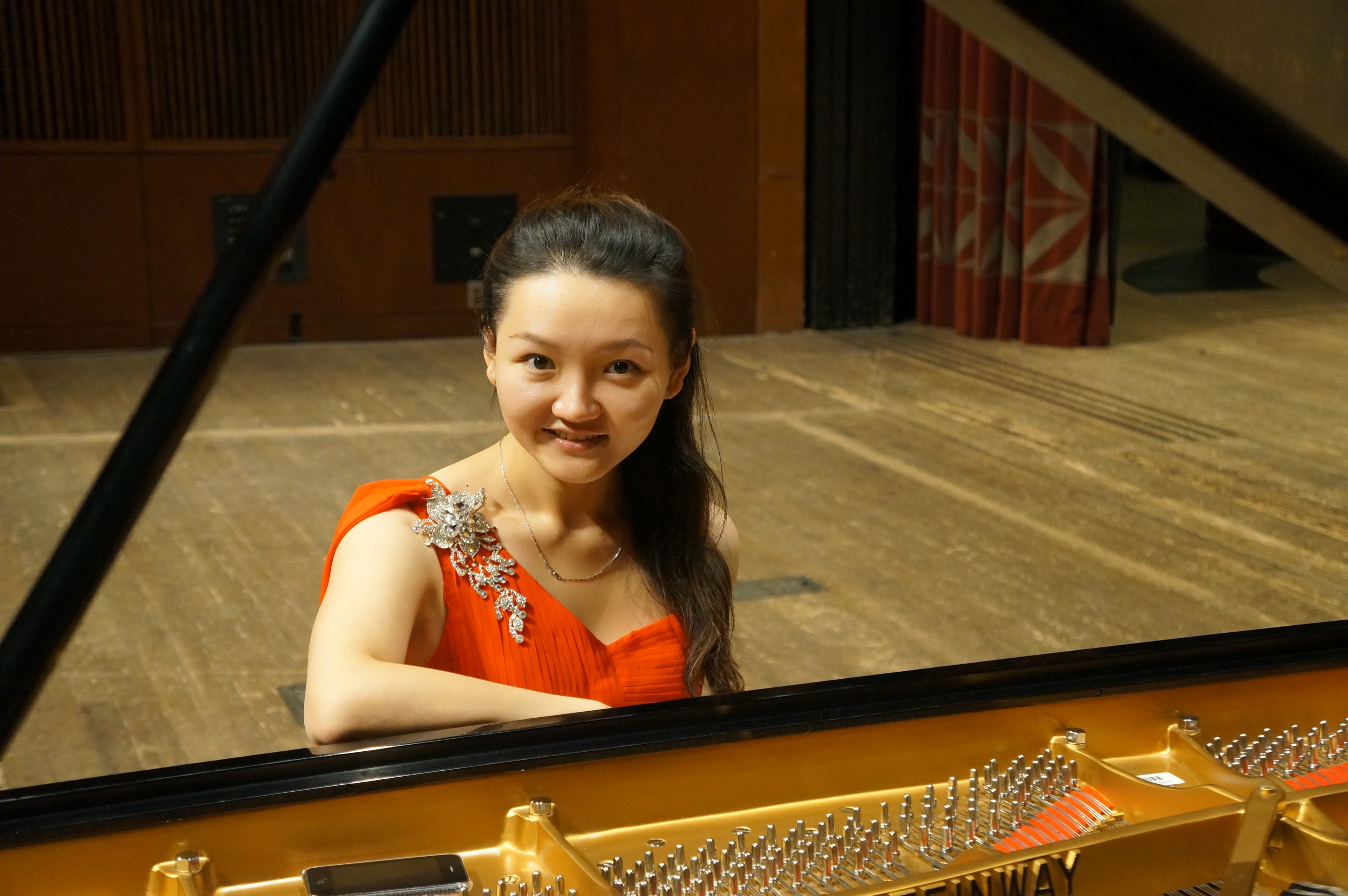 Pianist rehearsing at a grand piano in a studio